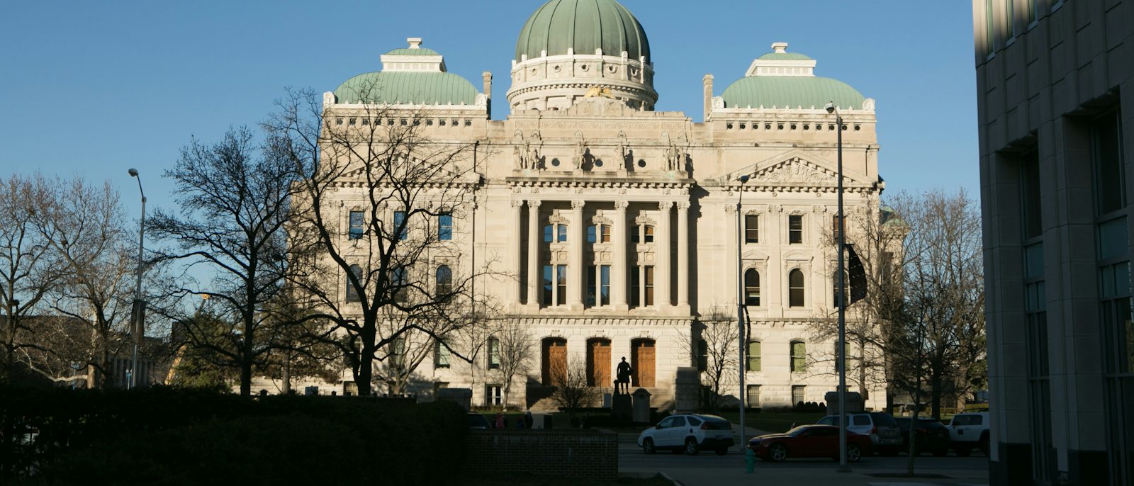 The Indiana Statehouse in Indianapolis under a blue sky