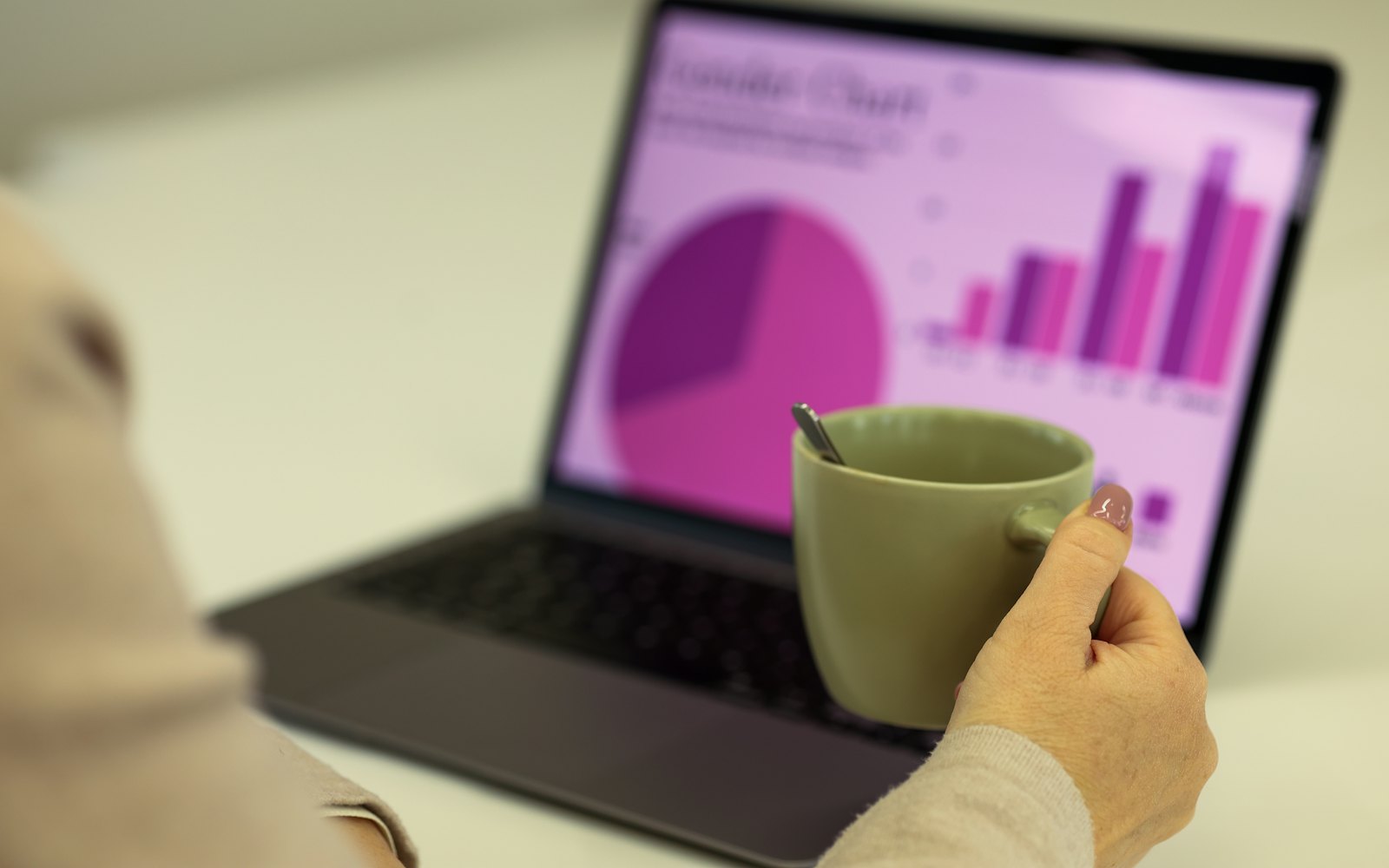 A person at a laptop showing a colorful chart