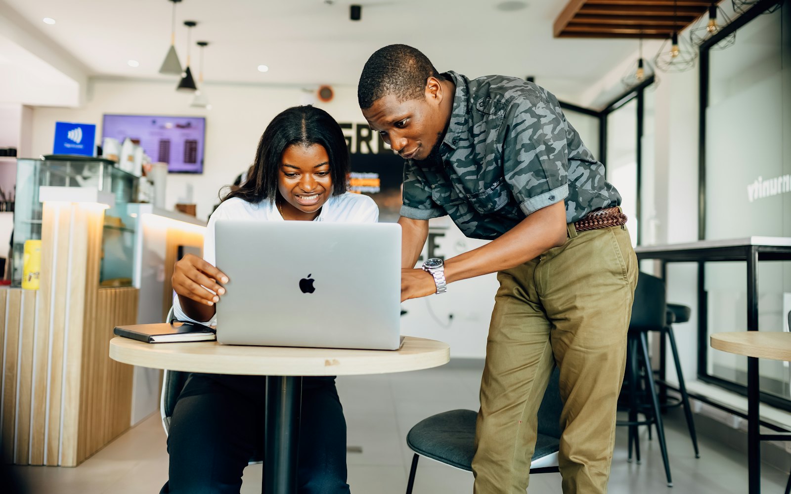 A man and a woman looking at a laptop