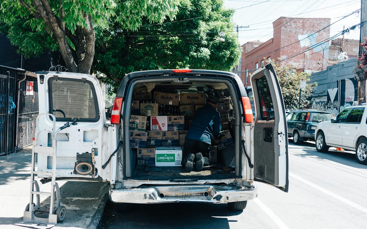 A white service van with its back doors open, ready for the next job