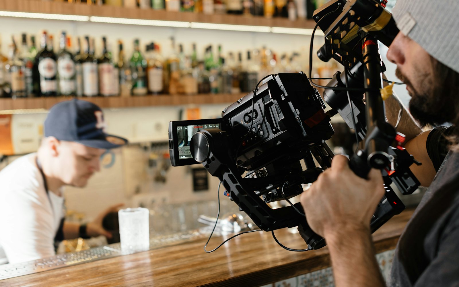 A filmmaker holding a video camera on a gimbal