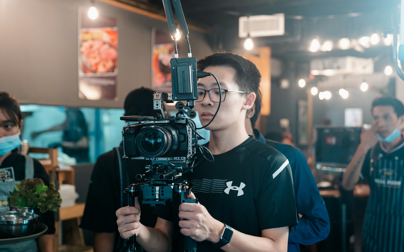 A videographer filming inside a restaurant