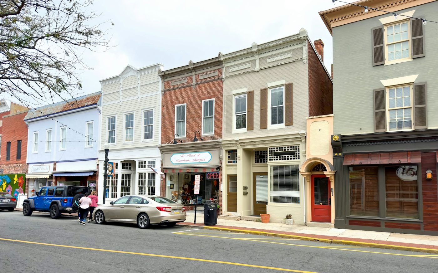 A row of small brick storefronts along a main street